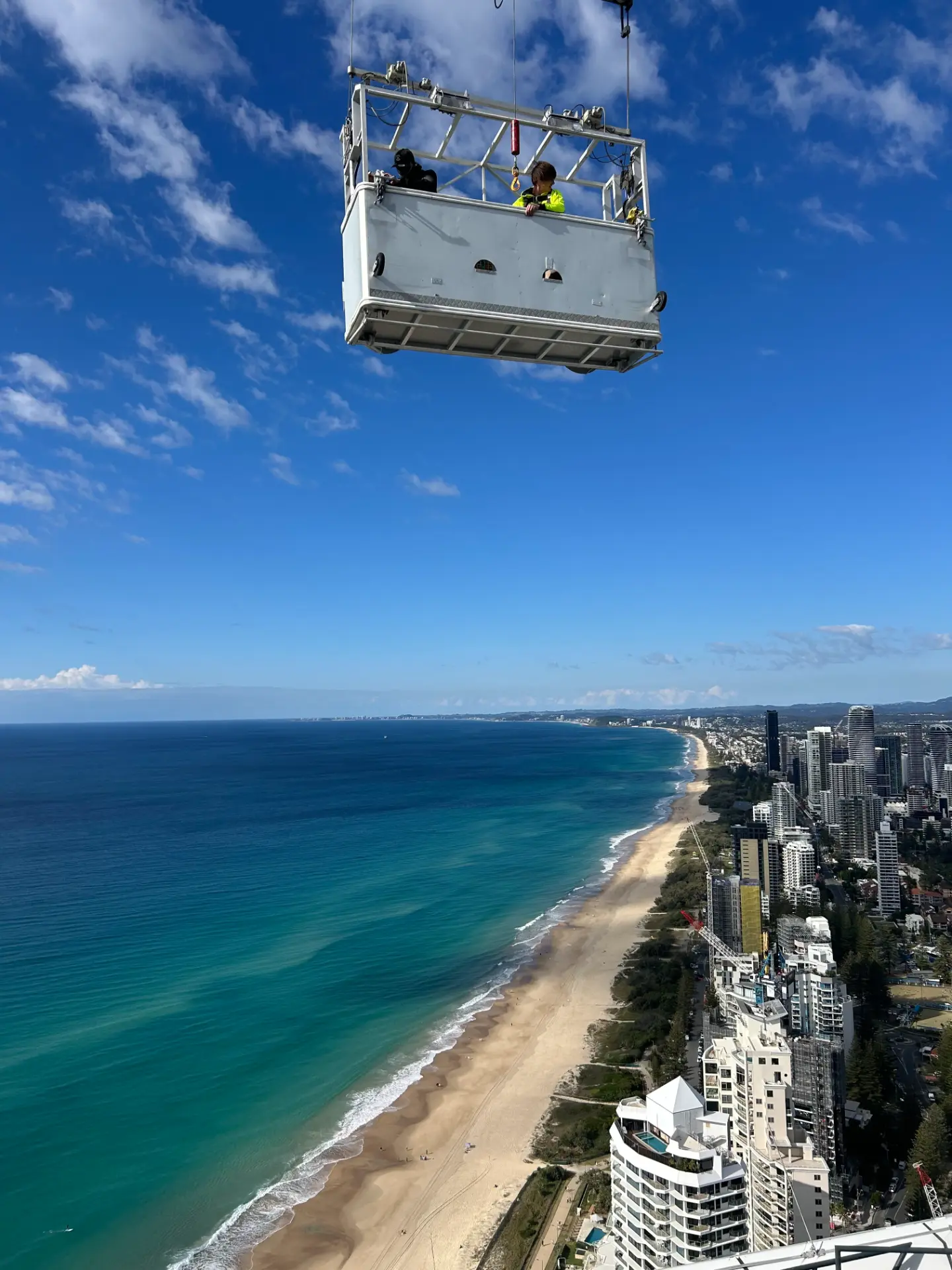 Suspended access platform above the Gold Coast coastline for high-rise glazing work