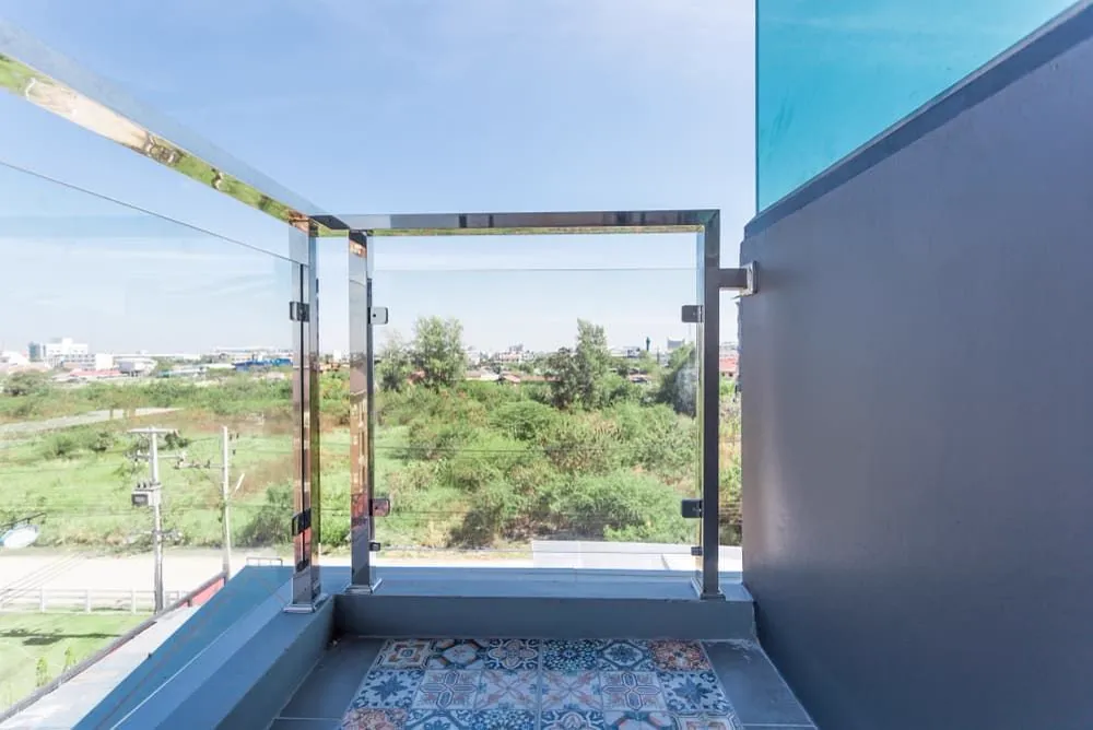 Glass balustrade with a view of trees, glass repair in Gold Coast, QLD