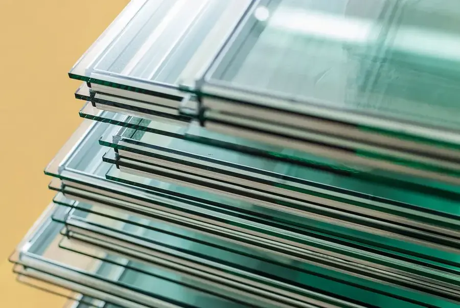Stack of glass sheets photographed against an orange background