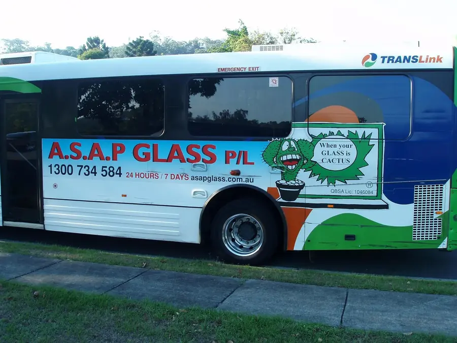 ASAP Glass branded bus advertisement on a suburban street