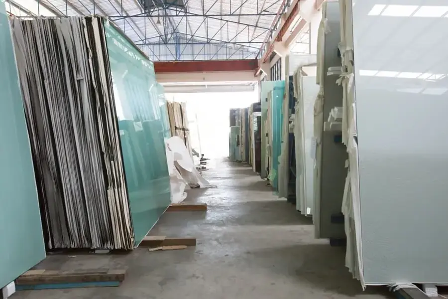 Warehouse aisle stacked with large glass sheets
