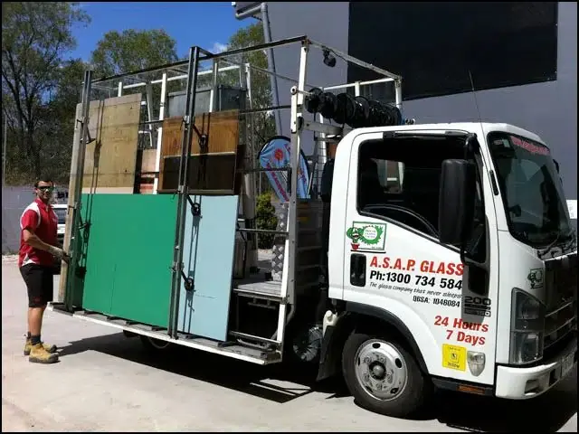 ASAP Glass branded truck loaded with glass panels, technician alongside