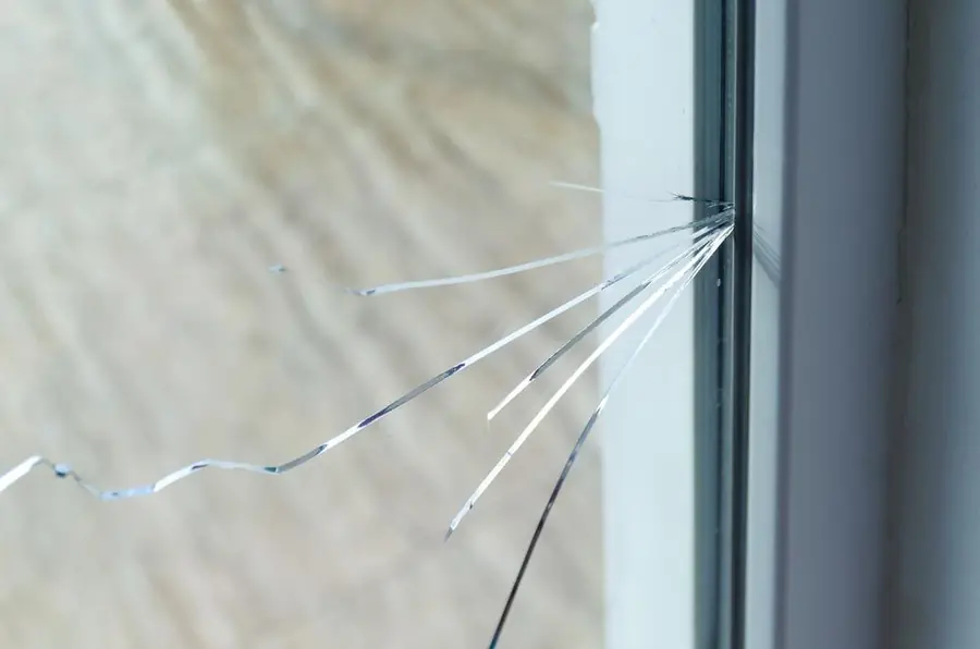 Dramatic radiating crack pattern across a glass pane