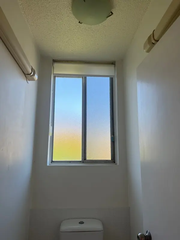 Obscured decorative glass pane installed for privacy in a Gold Coast bathroom
