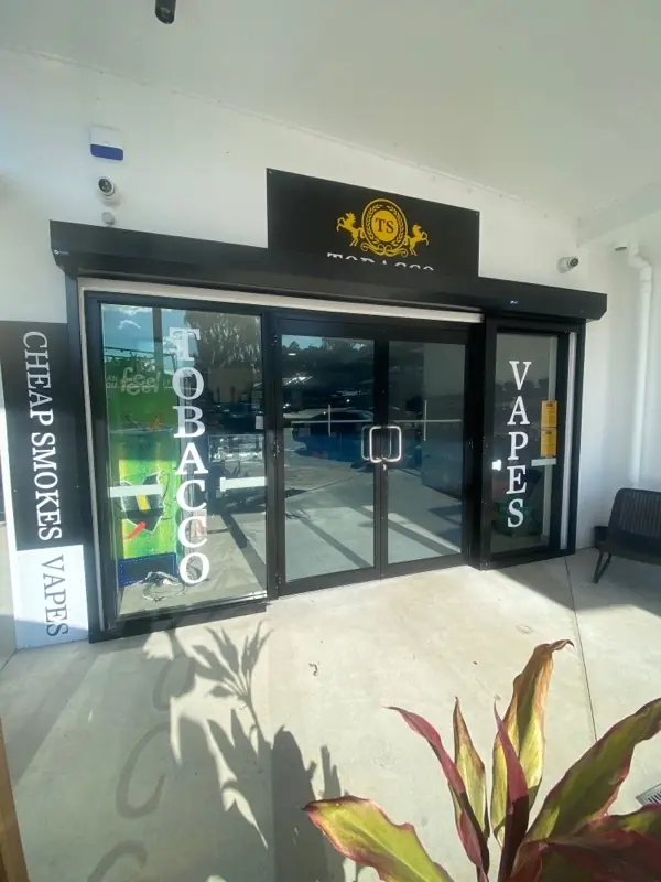 Restored aluminium-framed glass shopfront with sliding doors at a Gold Coast retail store