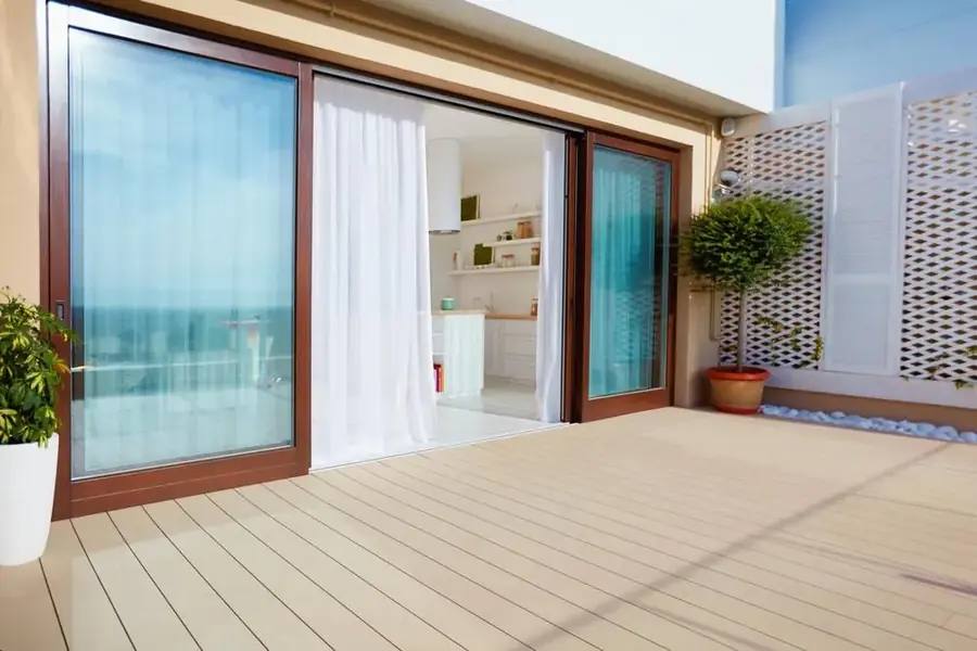 Timber-framed bifold doors opening onto a residential patio
