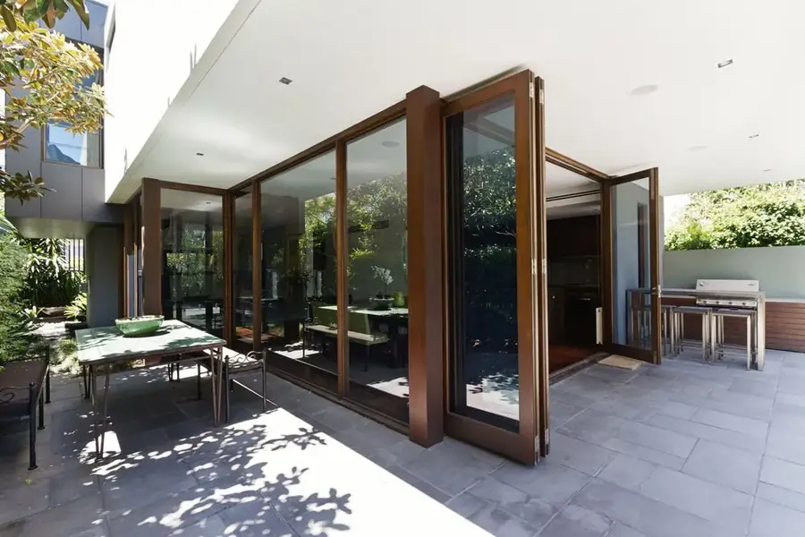 Timber-framed bifold glass doors opening onto a residential patio