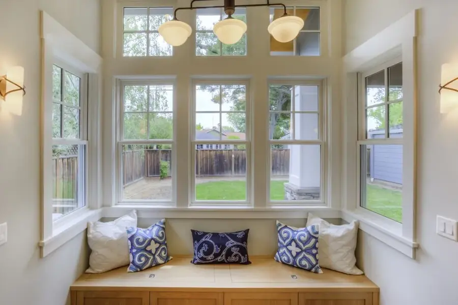 Bright bay window seat with cushions in a residential living room