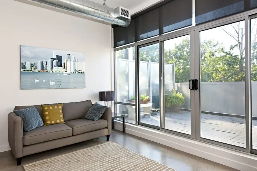 Residential living area with a large sliding glass door onto a courtyard