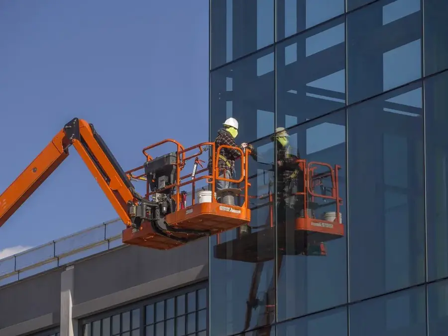 ASAP Glass technicians on an elevated work platform servicing a commercial glass facade