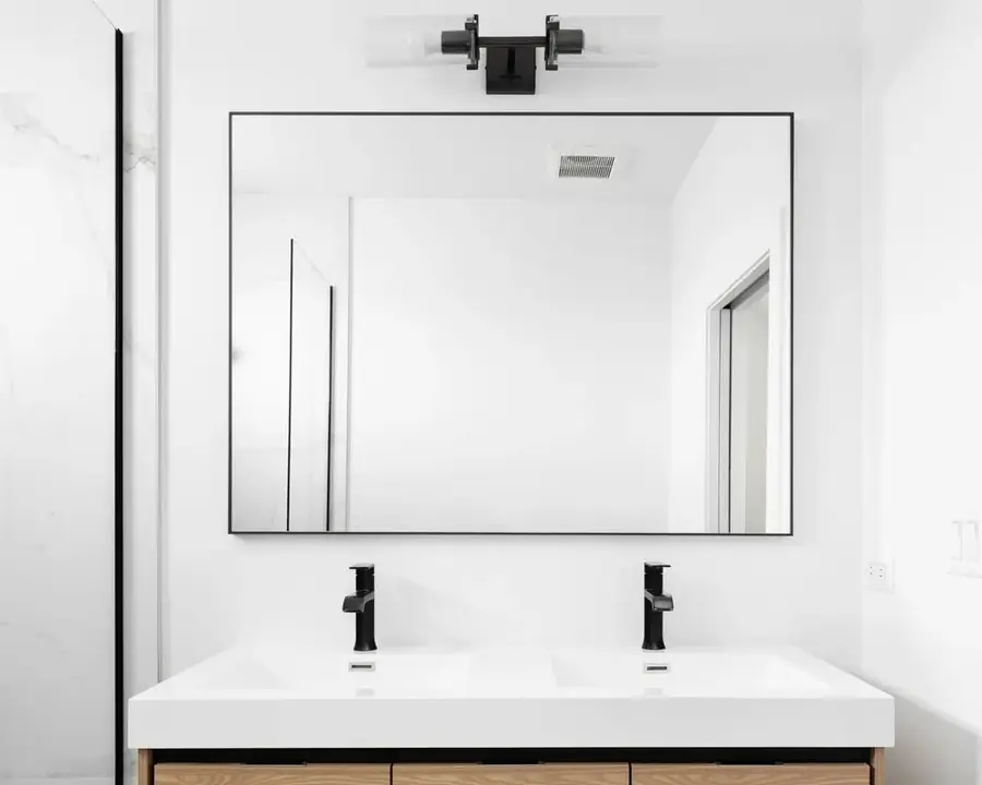 Wall-mounted mirror above a double vanity in a modern bathroom