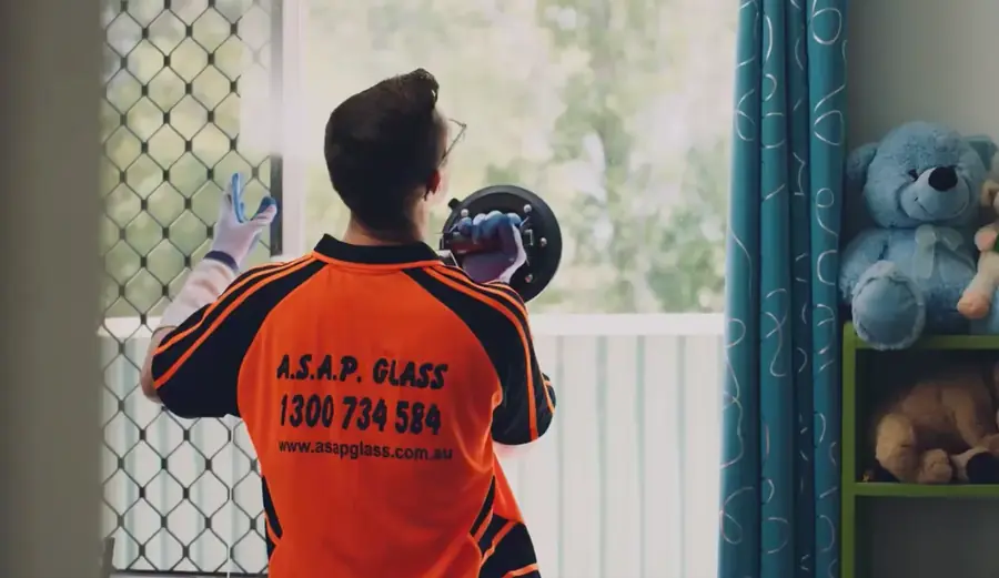 ASAP Glass technician in branded hi-vis workwear on site