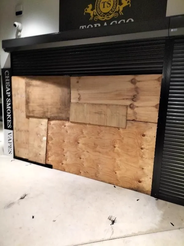 Shop front with wood cover before repair, Gold Coast