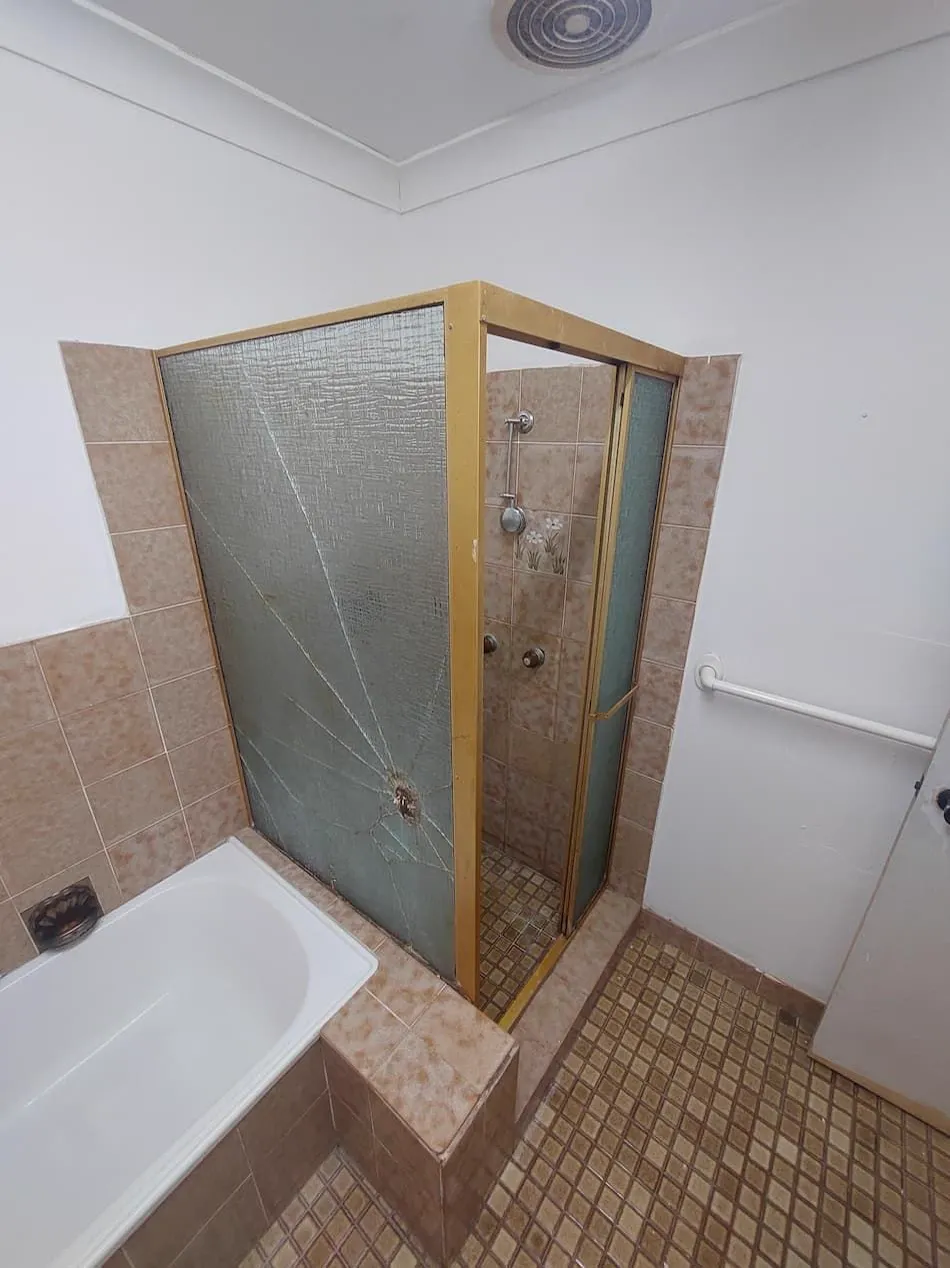 Broken shower glass before repair, Gold Coast